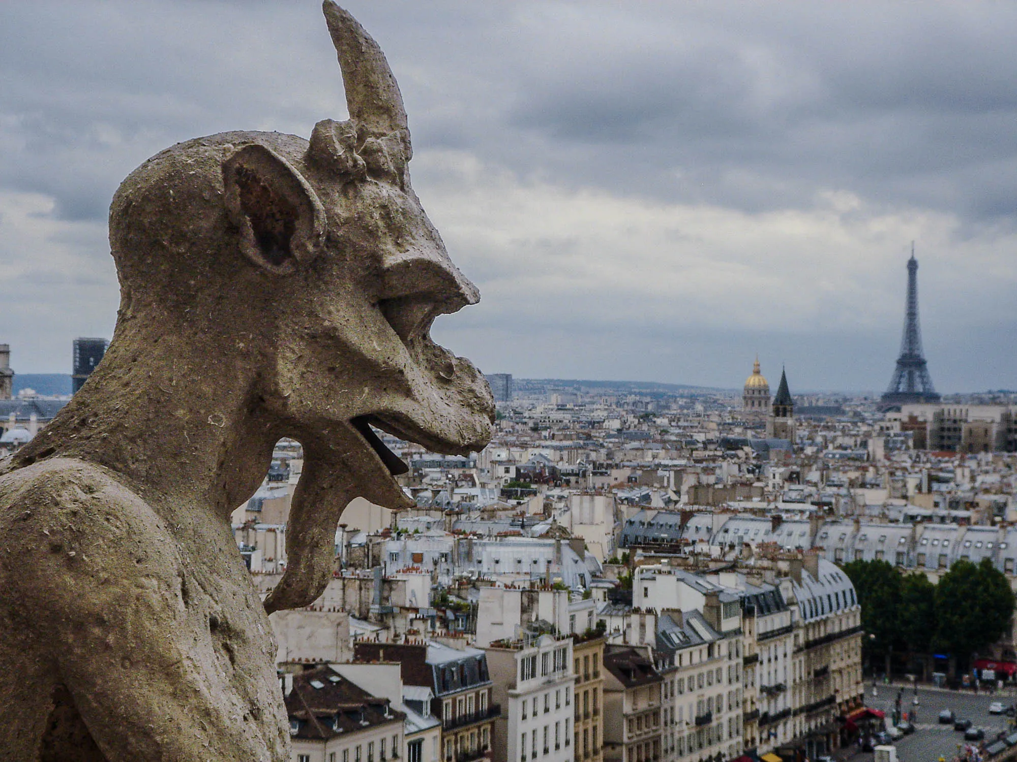 A grotesque looking out over Paris. in profile looking over Paris. The Eiffle tower is visible in the background